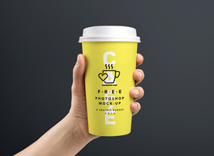 Coffee Cup In Hand MockUp | GraphicBurger